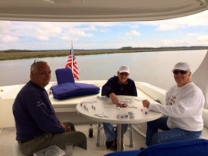 Enjoying a game of Mexican  Train especially with blue skies and light breezes to keep the bugs away in our remote New Tea Kettle anchorage. 