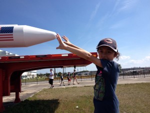 Looks can be deceiving thanks to a camera angle that makes Jassa look as though he can touch the nose of a HUGE rocket displayed outside the NASA   assembly building.