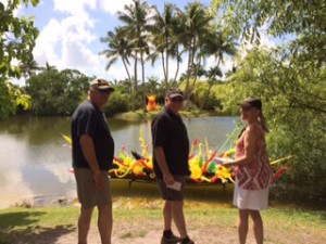 Cliff, Gary and Carolyn get up close to a rowboat filled with blown glass shapes.