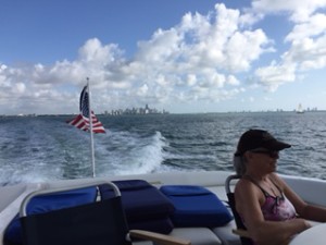 Miami is just a small bit of skyline as we take off across Biscayne Bay.  And Carolyn enjoys a bit of sun.